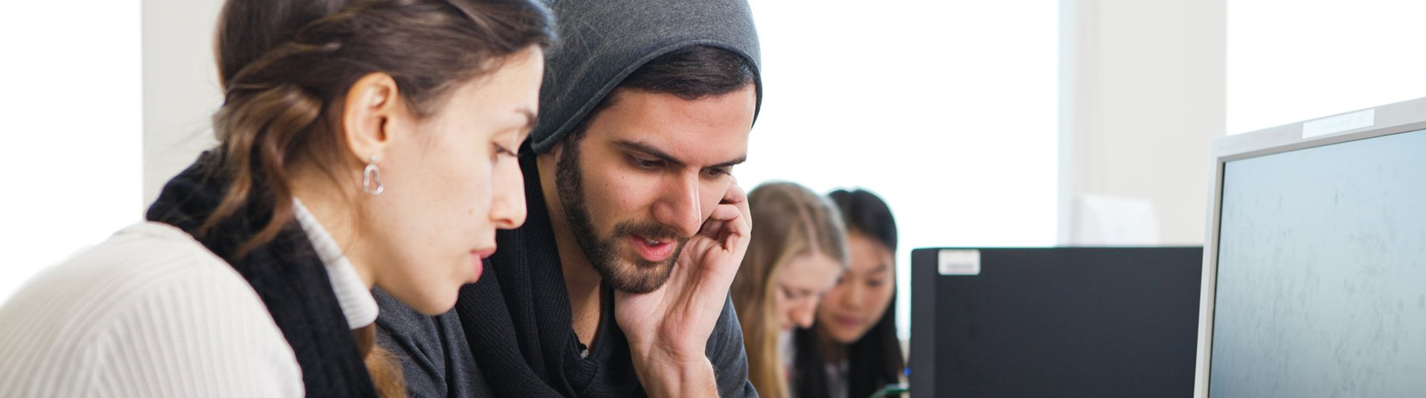 Applied Mathematics: A young woman and a young man are sitting in front of a screen and discussing. 